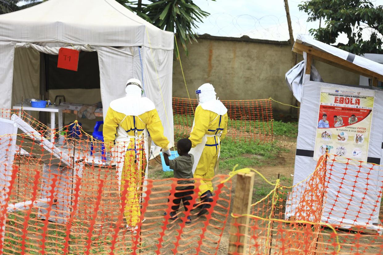 Health workers walk with a boy suspected of having the Ebola virus at a treatment center in Beni in the Democratic Republic of Congo on Sept. 9, 2018. (Photo: ASSOCIATED PRESS)