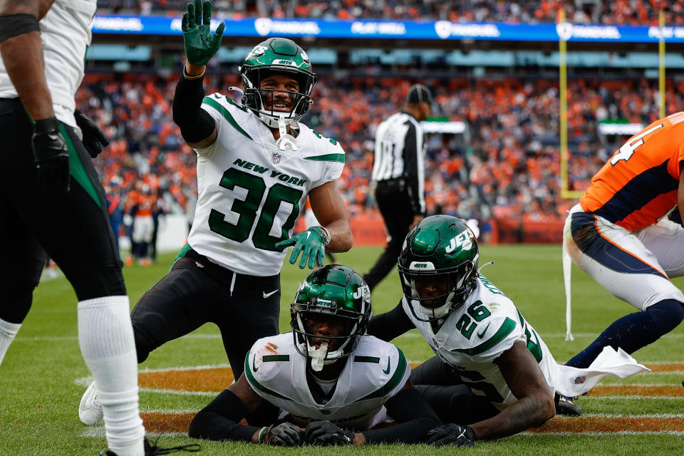 Oct 23, 2022; Denver, Colorado, USA; New York Jets cornerback Michael Carter II (30) and cornerback Brandin Echols (26) celebrate after a play from cornerback Sauce Gardner (1) in the fourth quarter against the Denver Broncos at Empower Field at Mile High. Mandatory Credit: Isaiah J. Downing-USA TODAY Sports