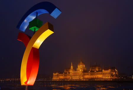 The Hungarian Parliament is seen behind Hungary's Olympic logo at a promotional spot as the Hungarian capital bids for the 2024 Olympic Games, in central Budapest, Hungary January 31, 2017. REUTERS/Laszlo Balogh