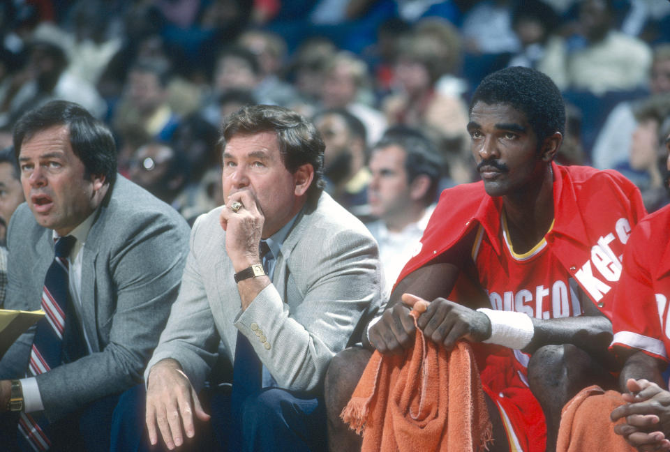 Ralph Sampson of the Houston Rockets sits next to head coach Bill Fitch on the bench against the Washington Bullets during an NBA game circa 1984 at the Capital Centre in Landover, Maryland. Sampson played for the Rockets from 1983-87. (Photo by Focus on Sport/Getty Images)