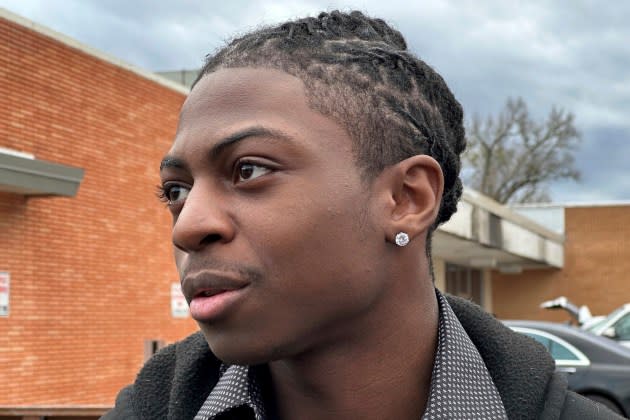 Darryl George, an 18-year-old high school junior, stands outside a courthouse in Anahuac, Texas, on Wednesday, Jan. 24, 2024. A judge ordered Wednesday that a trial be held next month to determine whether George can continue being punished by his district for refusing to change a hairstyle he and his family say is protected by a new state law.  (AP Photo/Juan A. Lozano) - Credit: AP