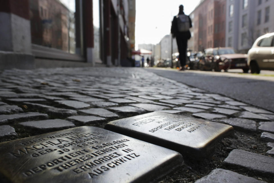 In this picture taken Monday, March 10, 2014 at the Rosa-Luxemburg-Street in the historic Berlin neighborhood 'Scheunenviertel', people pass so called 'Stolpersteine', or stumbling stones which remember to Jews killed by the Nazis. The epicenter of the Holocaust, the city where Hitler signed the death warrants of 6 million Jews, seems an unlikely candidate for the world’s fastest growing Jewish community. But despite this stigma of Nazism, Berlin’s dynamic, prosperous present and its rich, pre-World War II Jewish past initially attracted an influx from the former Soviet Union and has continued with the arrival of thousands of Israelis and smaller numbers of often young immigrants from Australia, France, the United States and elsewhere. (AP Photo/Markus Schreiber)