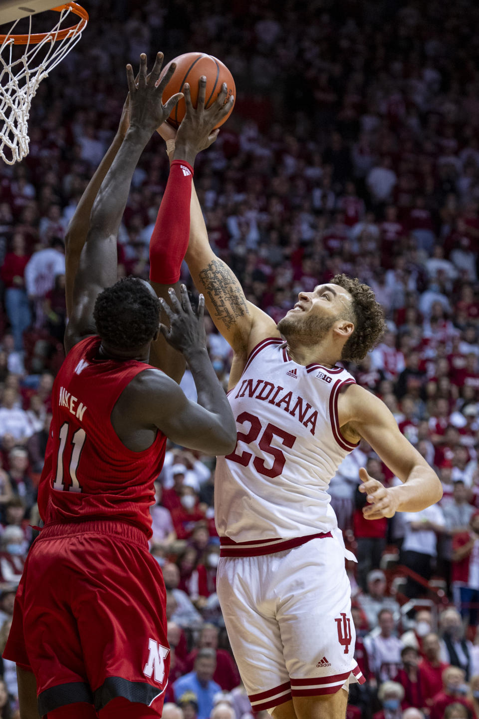 Indiana forward Race Thompson (25) battles for a rebound with Nebraska forward Lat Mayen (11) during the second half of a NCAA college basketball game, Saturday, Dec. 4, 2021, in Bloomington, Ind. (AP Photo/Doug McSchooler)