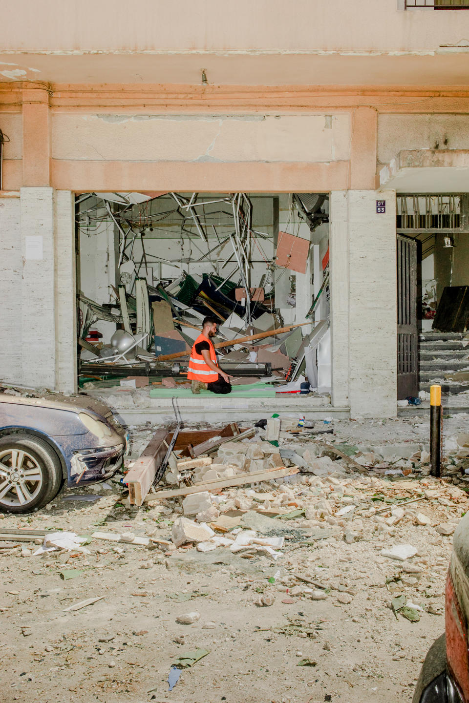 A volunteer named Ahmad, who works with a Palestinian organization helping victims of the massive explosion in Beirut, prays amid rubble on Aug. 5, 2020. | Myriam Boulos