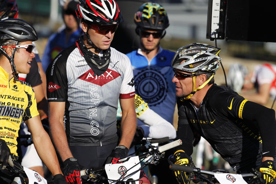 Lance Armstrong, right, chats with other riders at the start line of the Power of Four mountain bicycle race at the starting line in Snowmass Village, Colo., early Saturday, Aug. 25, 2012. The race is the first public appearance for Armstrong since the U.S. Anti-Doping Association stripped him of his seven Tour de France championships and banned him for life from the sport.