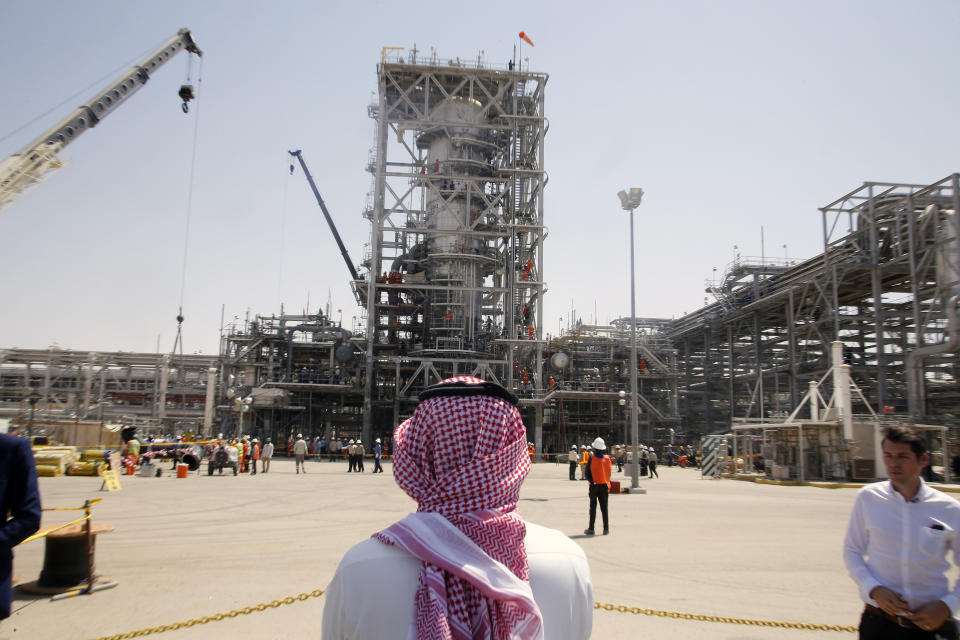 In this photo opportunity during a trip organized by Saudi information ministry, a man stands in front of the Khurais oil field in Khurais, Saudi Arabia, Friday, Sept. 20, 2019, after it was hit during Sept. 14 attack. Saudi officials brought journalists Friday to see the damage done in an attack the U.S. alleges Iran carried out. Iran denies that. Yemen's Houthi rebels claimed the assault. (AP Photo/Amr Nabil)
