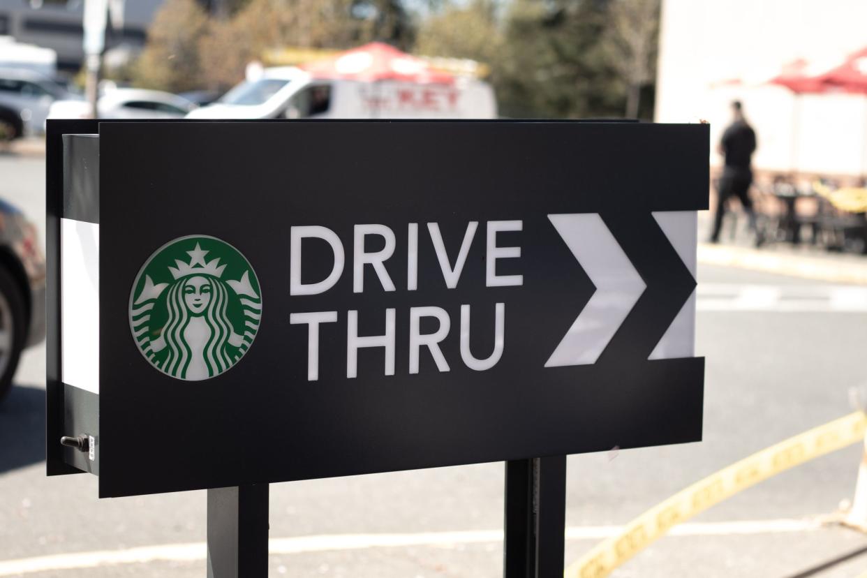 Courtenay,Canada - April 22,2021: Cars lining up to order food using drive-thru facilitiy at local Starbucks Coffee Shop