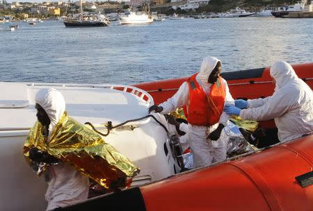 Migrants who survived a shipwreck arrive at the Lampedusa harbour February 11, 2015. REUTERS/Antonio Parrinello