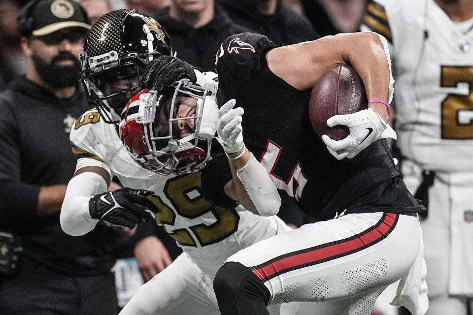 New Orleans Saints cornerback Paulson Adebo (29) forces out Atlanta Falcons wide receiver Drake London (5) during the second half of an NFL football game, Sunday, Nov. 26, 2023, in Atlanta. The Atlanta Falcons won 24-15. (AP Photo/John Bazemore)