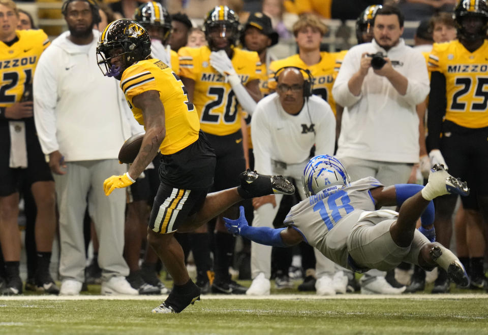 Missouri wide receiver Luther Burden III runs past Memphis defensive back DeAgo Brumfield (18) during the first half of an NCAA college football game Saturday, Sept. 23, 2023, in St. Louis. (AP Photo/Jeff Roberson)