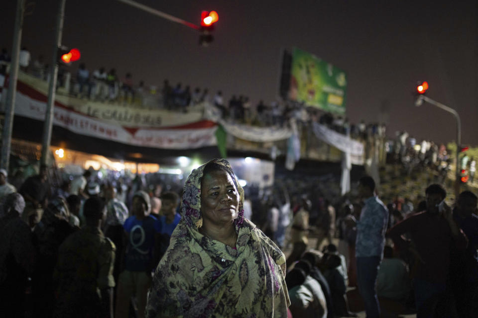 In this Thursday, April 18, 2019 photo, Amal al-Zein, an activist who was detained under former Sudanese President Omar al-Bashir, attends a protest in Khartoum, Sudan. Khartoum, Sudan. Al-Bashir, driven from power in April 2019, and now languishing in a prison where his opponents were once jailed and tortured, is more vulnerable than ever to a decade-old international arrest warrant for war crimes committed in Darfur. But the military, which forced him from power after four months of mass protests, has said it will not extradite him to the International Criminal Court at the Hague, and even many opponents including al-Zein have said they prefer he be tried in Sudan. (AP Photos/Salih Basheer)