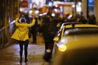 People raise their arms to show their hands as they walk towards police on a side road near the Champs Elysees Avenue after shooting incident in Paris, France, April 20, 2017. REUTERS/Benoit Tessier