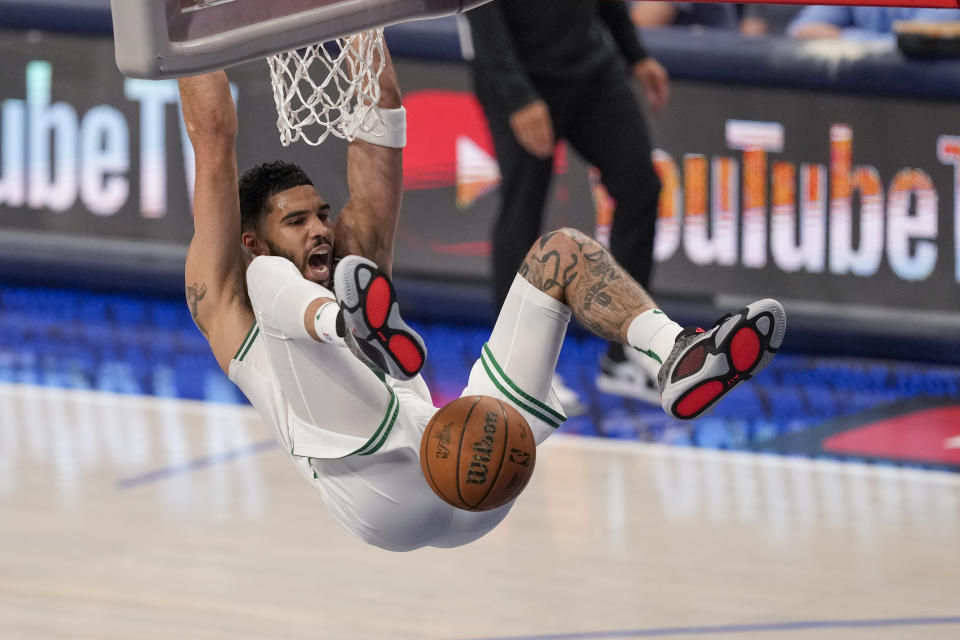 Boston Celtics forward Jayson Tatum reacts after scoring a basket against the Dallas Mavericks during the first half in Game 3 of the NBA basketball finals, Wednesday, June 12, 2024, in Dallas. (AP Photo/Sam Hodde)