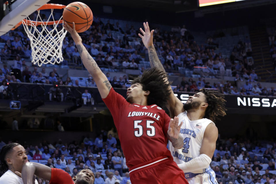 Louisville guard Skyy Clark (55) drives to the basket past North Carolina guard RJ Davis (4) during the second half of an NCAA college basketball game Wednesday, Jan. 17, 2024, in Chapel Hill, N.C. (AP Photo/Chris Seward)