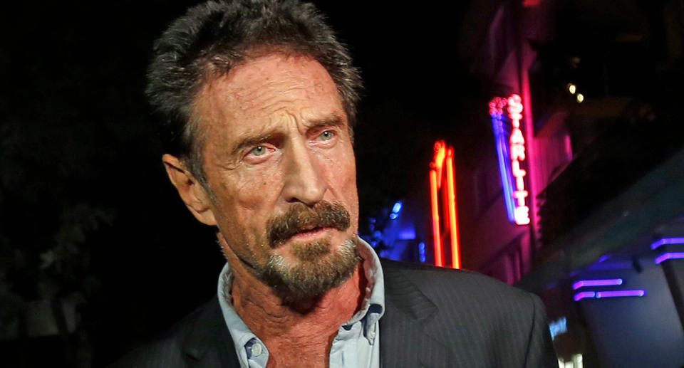 Anti-virus software founder John McAfee answers questions to reporters as he walks on Ocean Drive, in the South Beach area of Miami Beach, Florida, in 2012. Source: AAP