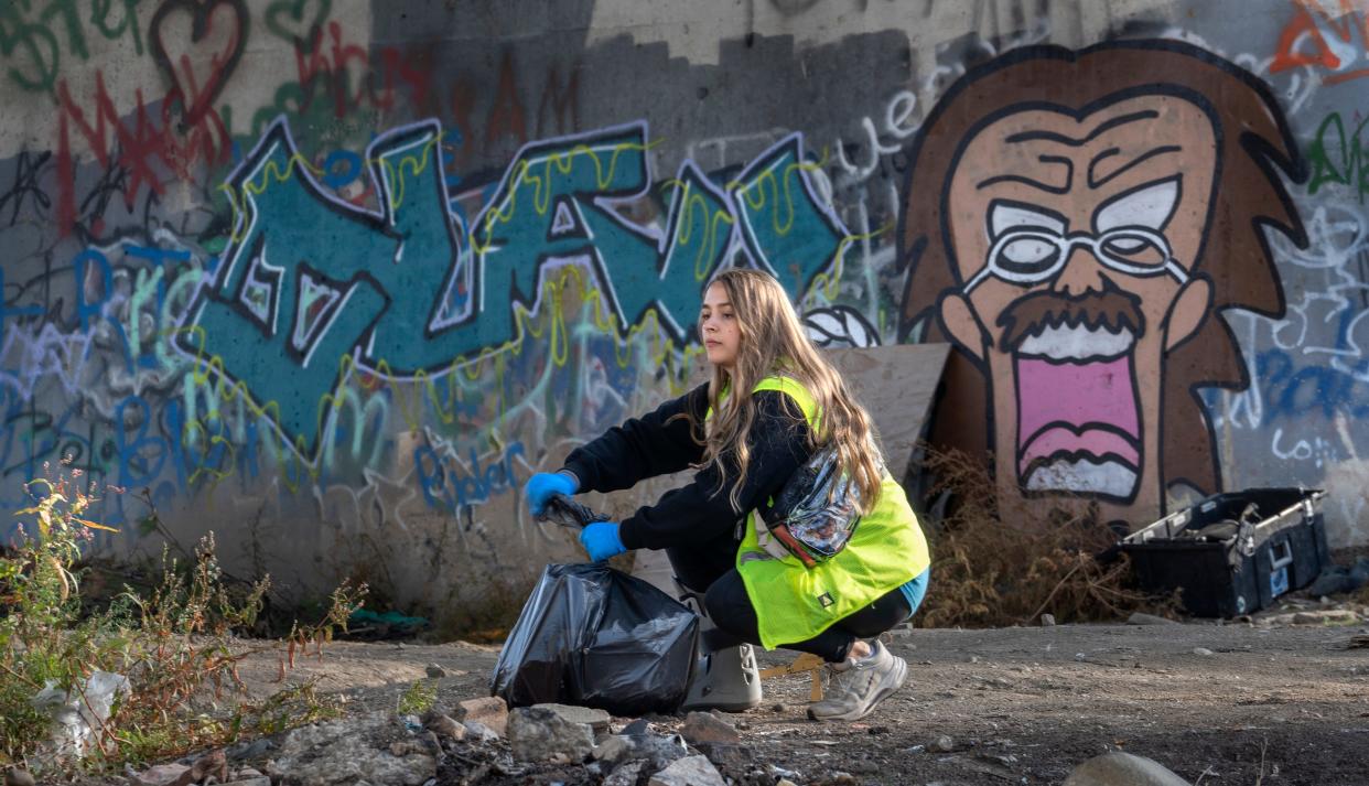 Ryann Davis joins other volunteers on a clean-up project Thursday, Nov. 9, 2023 on the east bank of the White River. Davis is the Manager of Clean Neighborhoods for Keep Indianapolis Beautiful’s Residential Programs.