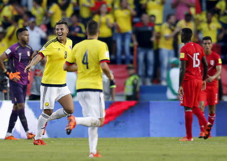 Colombia's Edwin Cardona (8) celebrates with teammate Arias (4) after scoring during their 2018 World Cup qualifying soccer match against Peru at the Roberto Melendez Stadium in Barranquilla, Colombia, October 8, 2015. REUTERS/John Vizcaino