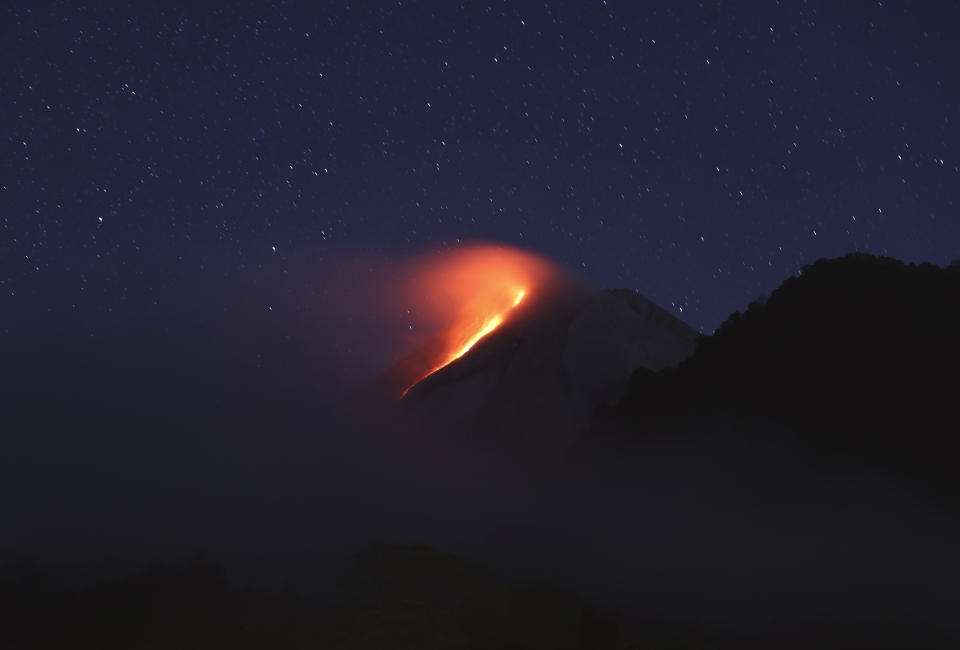 In this photo taken using slow camera shutter speed, hot lava runs down from the crater of Mount Merapi, in Sleman, Yogyakarta, Indonesia, early Wednesday, Aug. 11, 2021. The volcano is the most volatile of more than 120 active volcanoes in the country, and is one of the most active worldwide. (AP Photo/Trisnadi)