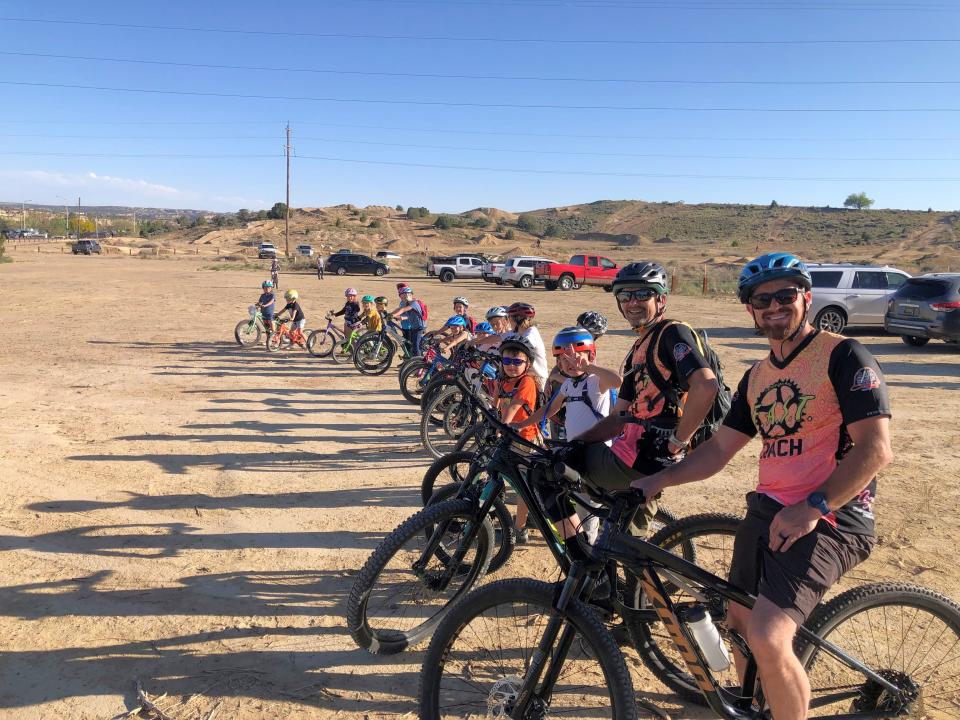 Participants in a youth cycling program run by Farmington Area Single Track prepare to set off on one of the rock trails near San Juan College.