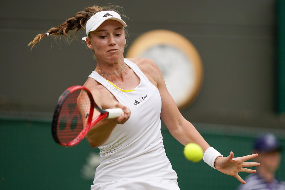 Kazakhstan's Elena Rybakina returns the ball to Australia's Ajla Tomljanovic during a women's singles quarterfinal match on day ten of the Wimbledon tennis championships in London, Wednesday, July 6, 2022. (AP Photo/Alberto Pezzali)