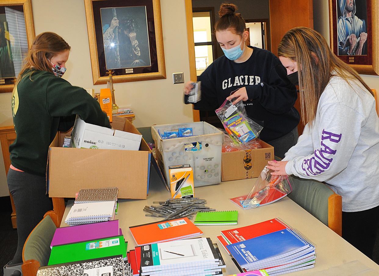 University of Mount Union students, from left, Hayley Maher, Alaina Miller and Alessia Kozell prepare gift bags containing school supplies for needy children through the Compassion Delivered Organization. The women worked on the project Saturday, Jan. 22, 2022, as part of a day of community service projects in celebration of the Rev. Martin Luther King Jr. The events were postponed from the holiday on Monday due to heavy snow.