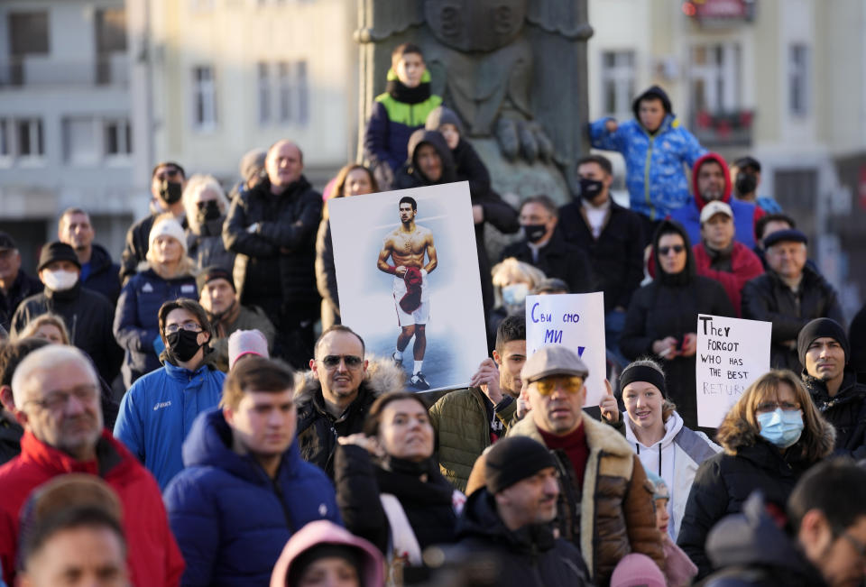 Supporters of Serbia's Novak Djokovic protest, in Belgrade, Serbia, Friday, Jan. 7, 2022. Several hundred people gathered outside Serbian parliament in a show of support for Serbian player Novak Djokovic as he battles the Australian legal system in an attempt to be allowed to stay in the country and compete in the Australian Open later this month. (AP Photo/Darko Vojinovic)