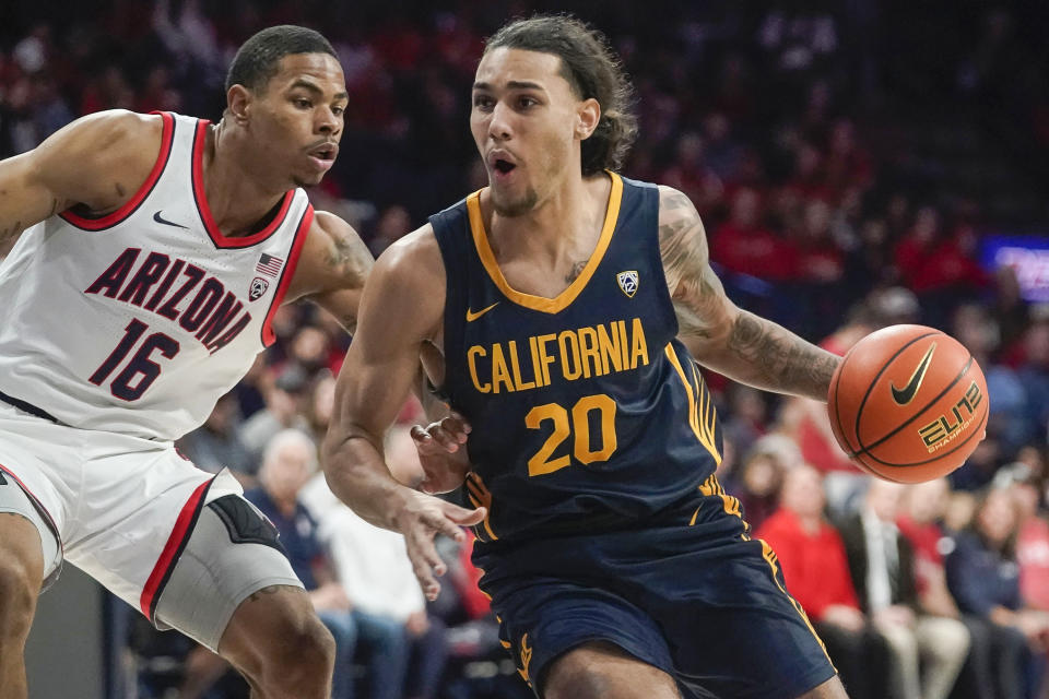 California's Jaylon Tyson (20) drives around Arizona's Keshad Johnson (16) during the first half of an NCAA college basketball game Thursday, Feb. 1, 2024, in Tucson, Ariz. (AP Photo/Darryl Webb)