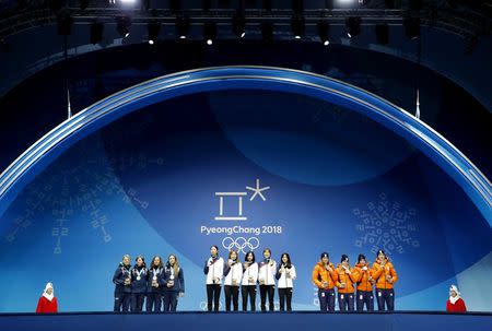 Medals Ceremony - Short Track Speed Skating Events - Pyeongchang 2018 Winter Olympics - Women's 3000 m - Medals Plaza - Pyeongchang, South Korea - February 21, 2018 - Gold medalists Shim Sukhee, Minjeong Choi, Kim Alang and Kim Yejin of South Korea, silver medalists Arianna Fontana, Lucia Peretti, Cecilia Maffei and Martina Valcepina of Italy, and bronze medalists Suzanne Schulting, Yara Van Kerkhof, Lara van Ruijven, Jorien ter Mors of the Netherlands on the podium. REUTERS/Eric Gaillard