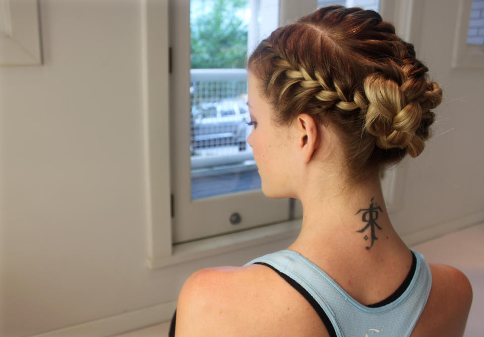 In this Aug. 1, 2012 photo, Danielle Maddox, 25, poses with the braid she had done at Maxine salon’s Braid Bar in Chicago. Salons from Los Angeles to New York and cities in between are opening "braid bars," offering special menus of different braid styles for a fixed price. (AP Photo/Caryn Rousseau)