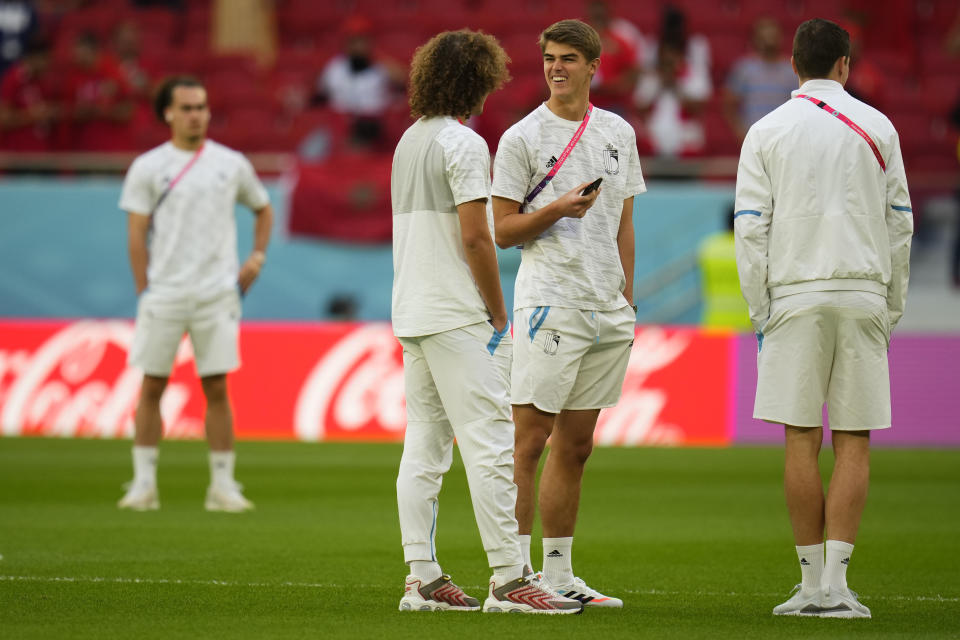 Belgium's Charles De Ketelaere, right, speaks with his teammate Wout Faes prior to the start of the World Cup group F soccer match between Belgium and Morocco, at the Al Thumama Stadium in Doha, Qatar, Sunday, Nov. 27, 2022. (AP Photo/Manu Fernandez)