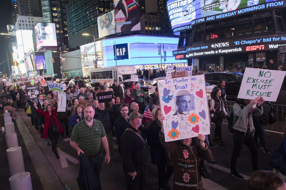 Protesters march through Times Square during a demonstration in support of special counsel Robert Mueller, Thursday, Nov. 8, 2018, in New York. A protest in New York City has drawn several hundred people calling for the protection of Mueller's investigation into potential coordination between Russia and President Donald Trump's campaign. (AP Photo/Mary Altaffer)