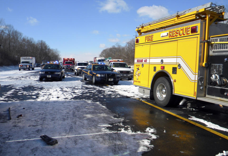 Emergency vehicles respond to two multi-vehicle accidents along Interstate 81 Wednesday morning, March 26, 2014, near Falling Waters, W.Va. West Virginia State Police say the two multi-vehicle accidents occurred during whiteout conditions, leaving two people dead and more than half a dozen others injured. (AP Photo/The Journal, Edward Marshall)