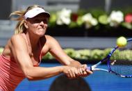 Maria Sharapova of Russia returns the ball to Caroline Garcia of France during the Madrid Open, at the Caja Magica (Magic Box) sports complex, on May 6, 2015