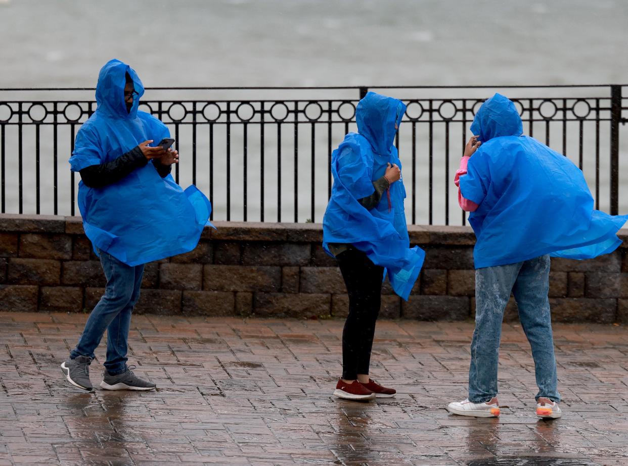 People walk in the rain and wind from Post-Tropical Cyclone Lee (Getty Images)