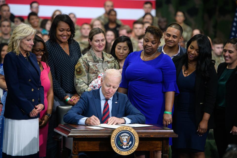 President Joe Biden signs an executive order to support military-connected families during his visit to Fort Liberty on Friday, June 9, 2023. 