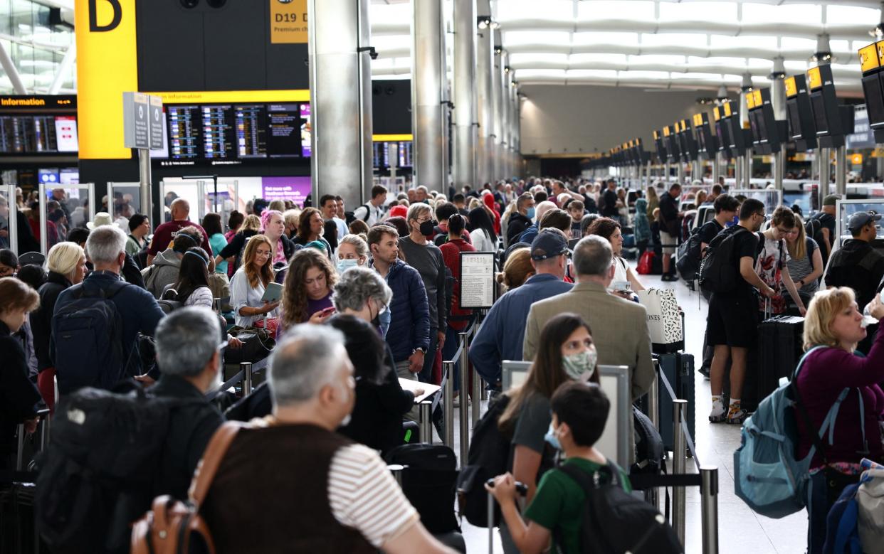 Passengers queue inside the departures terminal of Terminal 2 at Heathrow Airport in London, Britain, June 27, 2022. - HENRY NICHOLLS/ REUTERS