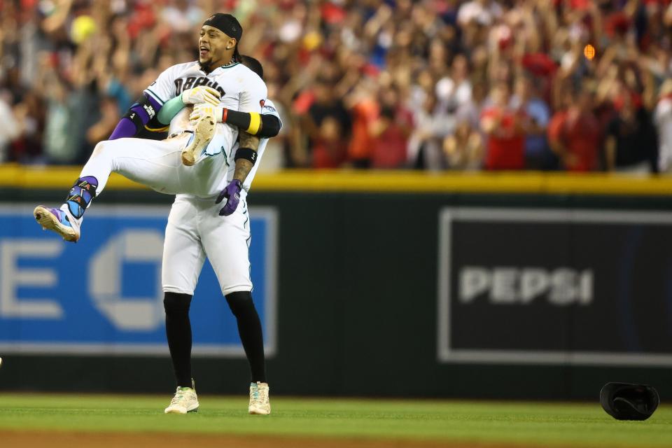 Diamondbacks second baseman Ketel Marte is lifted by his teammate after his walk off single in Game 3.