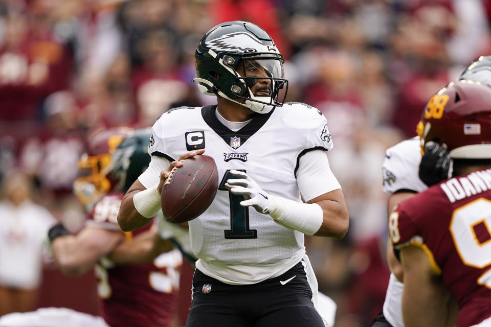 Philadelphia Eagles quarterback Jalen Hurts (1) looking doing field to throw the ball against the Washington Football Team during the first half of an NFL football game, Sunday, Jan. 2, 2022, in Landover, Md. (AP Photo/Alex Brandon)