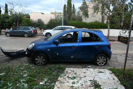 A damaged car next to a house that was hit by a rocket can be seen north of Tel Aviv, Israel, March 25, 2019. REUTERS/ Yair Sagi