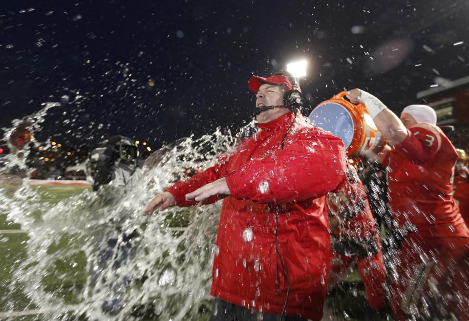 Laval Rouge et Or head coach Glen Constantin has water dumped on his head by Pierre Lavertu as they defeat the Calgary Dinos to win the Vanier Cup University Championship football game in Quebec City, Quebec, November 23, 2013. REUTERS/Mathieu Belanger (CANADA - Tags: SPORT FOOTBALL)