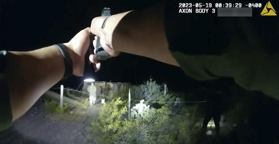 In this image taken from body camera video released Thursday, June 22, 2023, by U.S. Customs and Border Protection, an agent points a gun at tribal member Raymond Mattia, early Friday, May 19, in Tohono O'odham Nation, in southern Arizona. CPB said that agents were concerned that Mattia may have been carrying a handgun during the encounter in which Mattia was fatally shot. (U.S. Customs and Border Protection via AP)