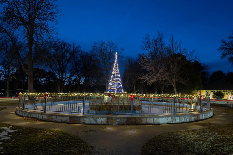 Holiday lights adorn the fountain on the east end of Pueblo's City Park.