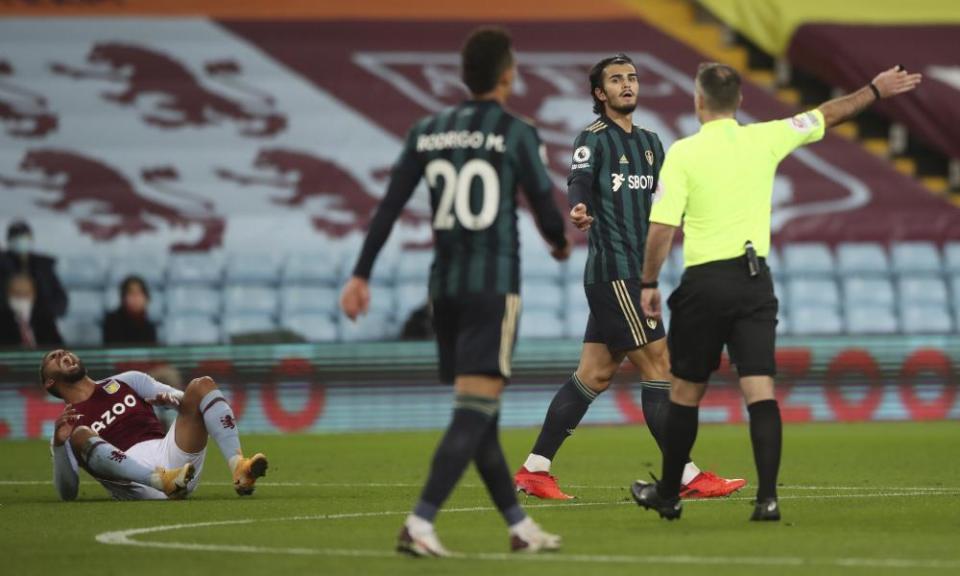 Leeds United’s Pascal Struijk with the referee Paul Tierney after fouling Aston Villa’s Douglas Luiz