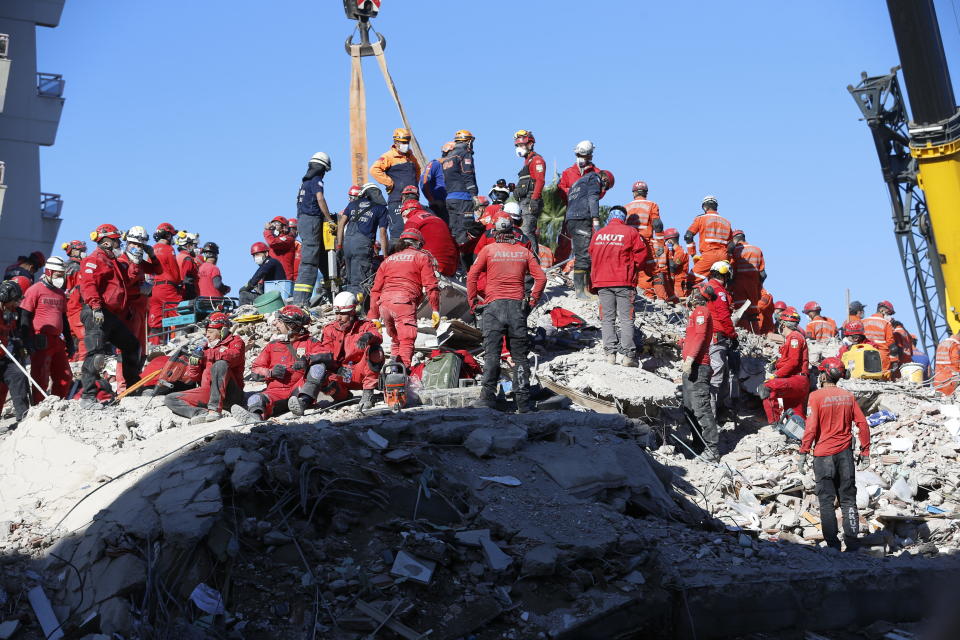 Members of rescue services search in the debris of a collapsed building for survivors in Izmir, Turkey, early Sunday, Nov. 1, 2020. Rescue teams continue ploughing through concrete blocs and debris of collapsed buildings in Turkey's third largest city in search of survivors of a powerful earthquake that struck Turkey's Aegean coast and north of the Greek island of Samos, Friday Oct. 30, killing dozens Hundreds of others were injured.(AP Photo/Darko Bandic)