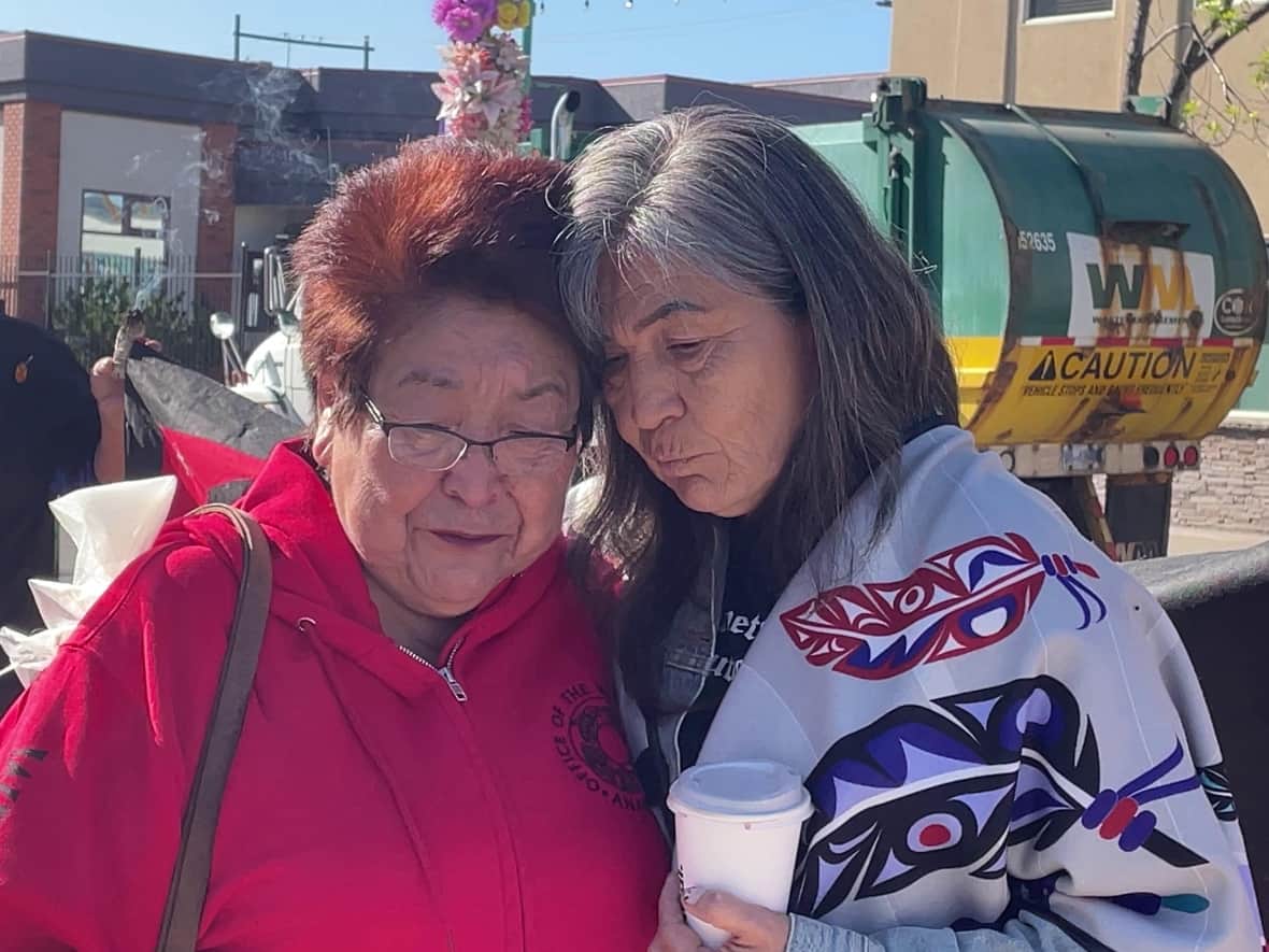 The families of two men who died in RCMP custody console each other outside the Prince George courthouse in June 2023.  Laura Holland, right, is Jared Lowndes's mother, and Virginia Pierre, left, is Dale Culver's aunt. (Betsy Trumpener/CBC - image credit)