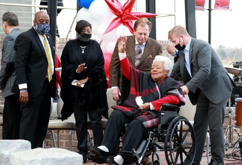 Naomi King, sister-in-law of the late Rev. Martin Luther King, Jr., waves as she arrives on Saturday at Plant Riverside District.