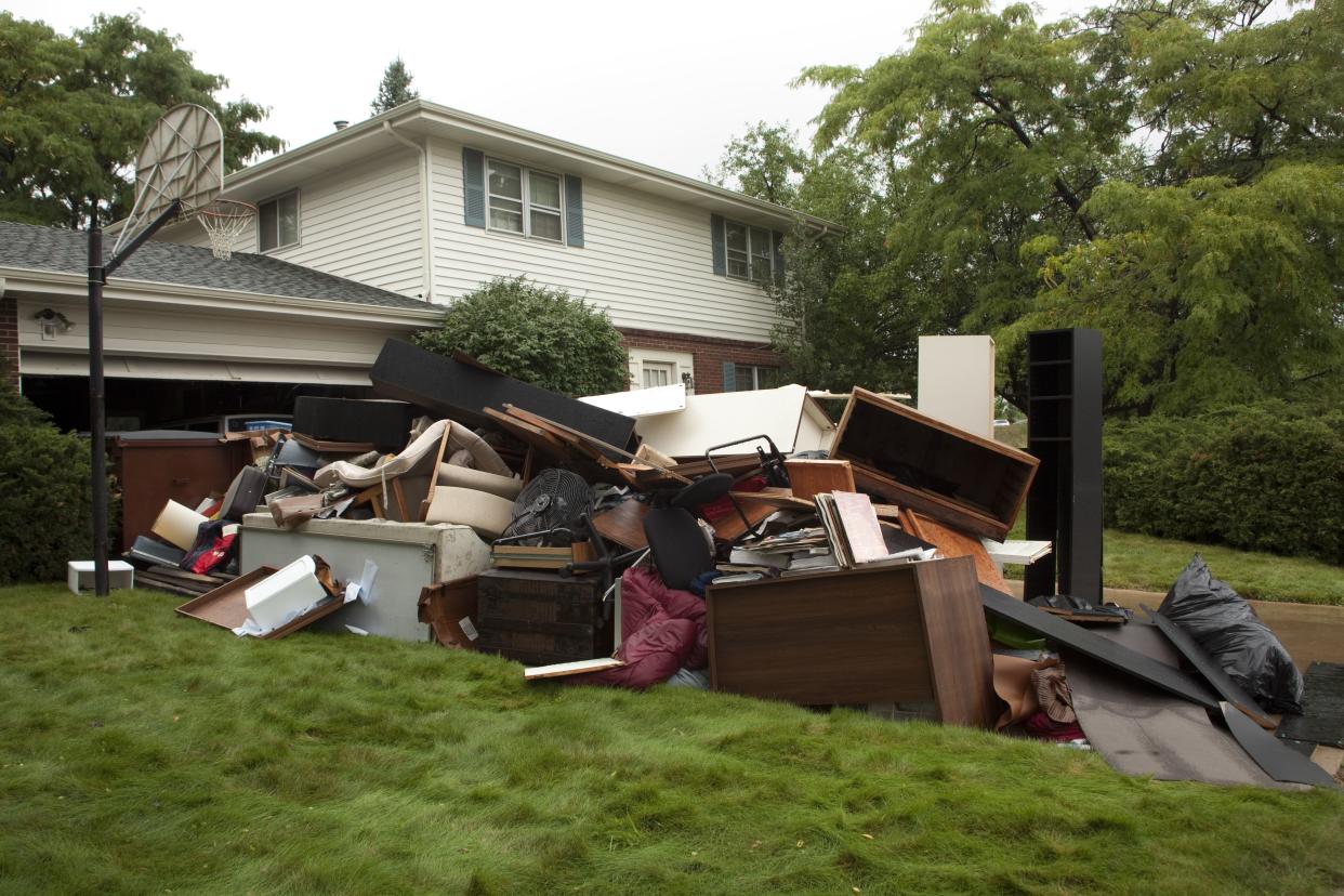 house with trash in front yard