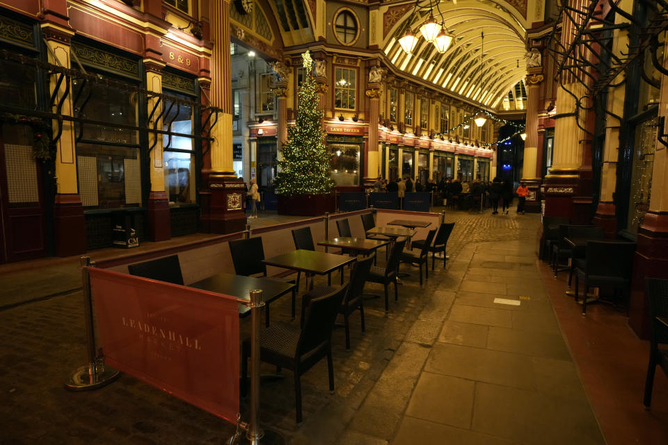 Empty seats outside a restaurant in London, Friday, Dec. 17, 2021. On what would normally be one of the busiest times for pubs and restaurants just before Christmas, customer numbers are down in central London due to concerns about the new omicron variant. Friday night in Central London was muted with one bar saying they have 30 customers inside when there should have been 170, with large amounts of cancellations in recent days. (AP Photo/Alastair Grant)