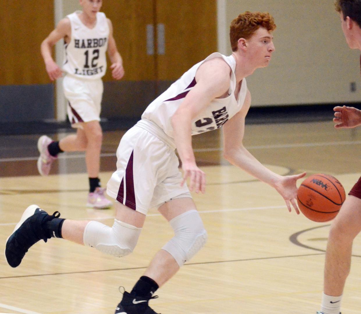 David Chamberlin and the Harbor Light boys' basketball team had another tough battle come Thursday when they opened league play vs. Ellsworth.