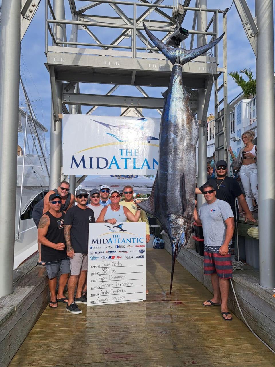 The crew of the Pipe Dreamer stand with their 889-pound blue marlin in the Mid-Atlantic Tournament.